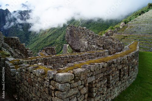 The ruins of the Incan citadel of Machu Picchu embraced by the fog during daytime, Peru photo
