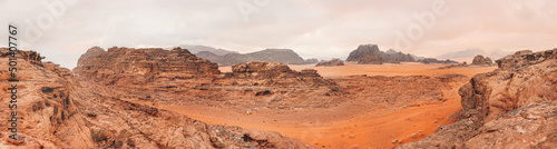 Red orange Mars like landscape in Jordan Wadi Rum desert  mountains background  overcast morning. This location was used as set for many science fiction movies