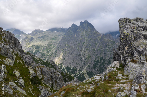 Landscape with rocky mountain ridge and sharp peaks hidden by clouds. High Tatras, Slovakia © Dmytro