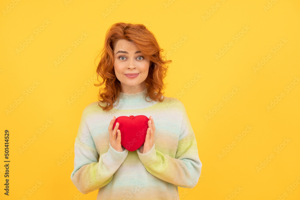 smiling redhead girl with red heart on yellow background. valentines smiling redhead girl with red heart on yellow background. valentines