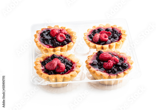 Delicious fruit tarts in plastic pack isolated on white