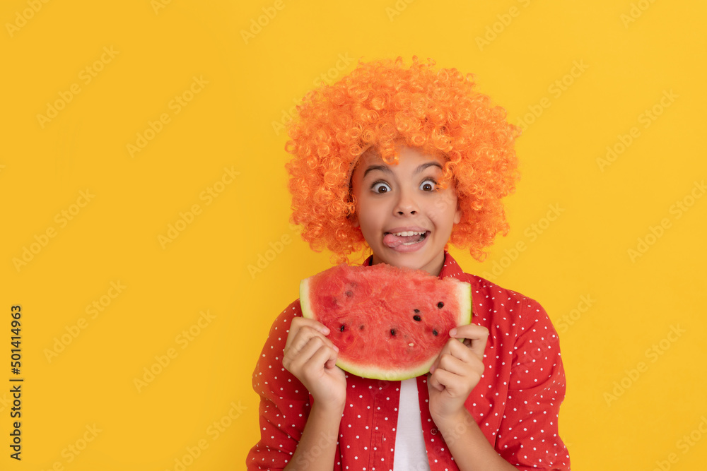 happy hungry child in fancy orange hair wig hold fresh ripe water melon slice fruit, hunger
