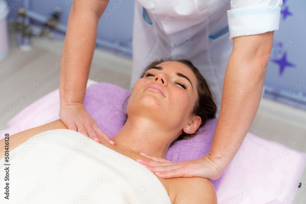 Facial massage. A woman is given a massage in a beauty salon. Close-up. Facial massage. A woman is given a massage in a beauty salon. Close-up.