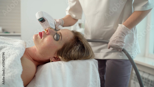 The cosmetic procedures for the face. Beauty treatments in the spa salon. Facial Skin Care. Laser removal of blood vessels on the face on a photon.