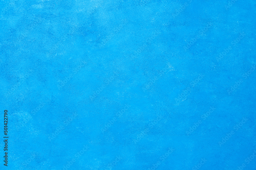 Artistic stylized textured surface of the color of sea wave. Abstract, grungy, decorative saturated blue background. Design element and decoration