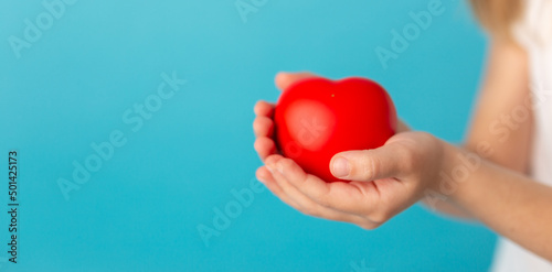 Fototapeta Naklejka Na Ścianę i Meble -  Child hands holding red heart, health care, love, organ donation, family insurance and CSR concept, world heart day, world health day, foster home care