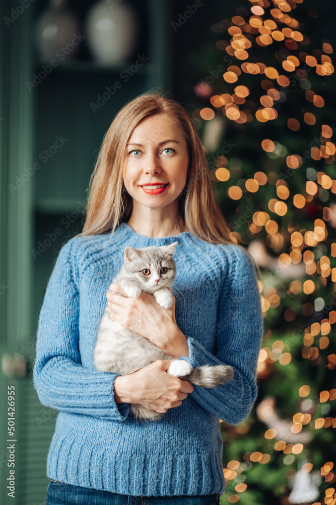 A woman with a cat hugs at home. A woman with a cat hugs at home.