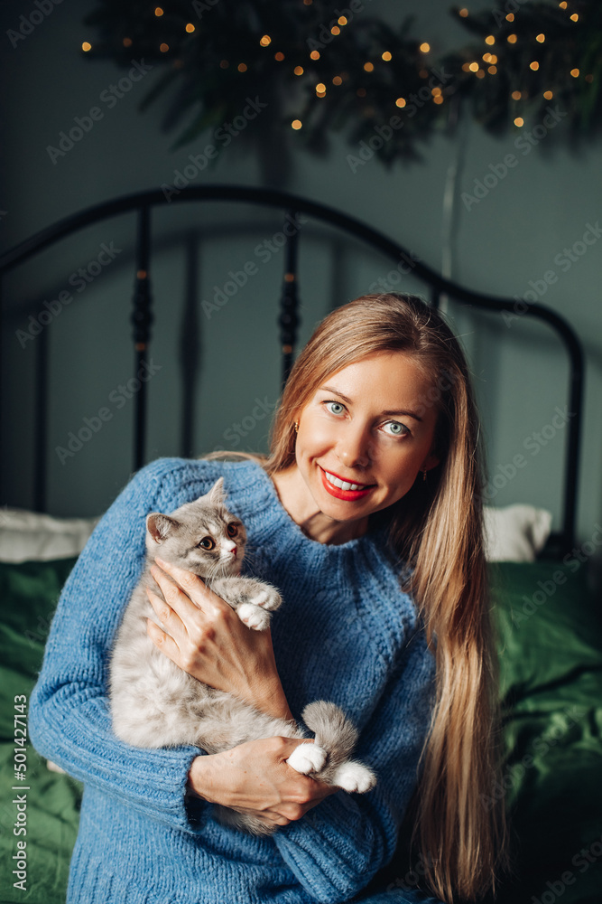 A woman with a cat hugs at home. A woman with a cat hugs at home.