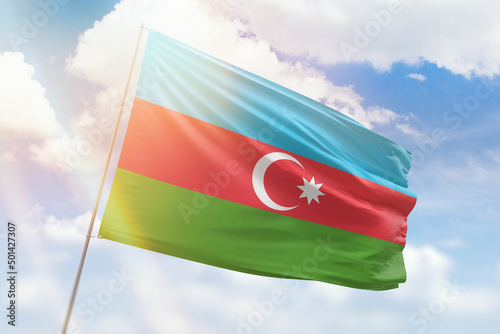 Sunny blue sky and a flagpole with the flag of azerbaijan