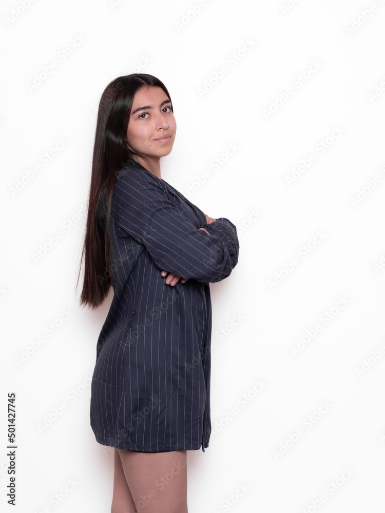 relaxed latina girl in profile looking at camera, isolated on white background, shopping concept relaxed latina girl in profile looking at camera, isolated on white background, shopping concept