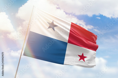 Sunny blue sky and a flagpole with the flag of panama photo