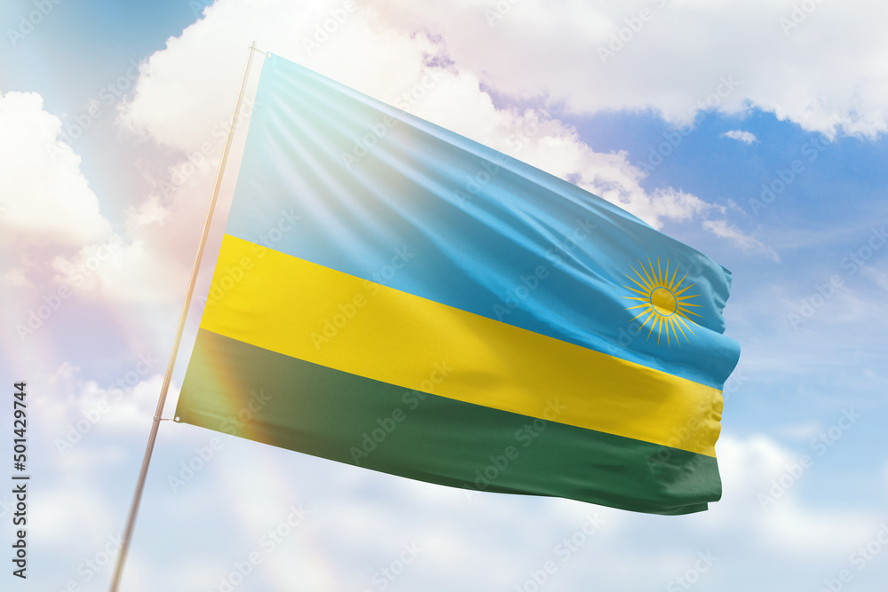 Sunny blue sky and a flagpole with the flag of rwanda Sunny blue sky and a flagpole with the flag of rwanda