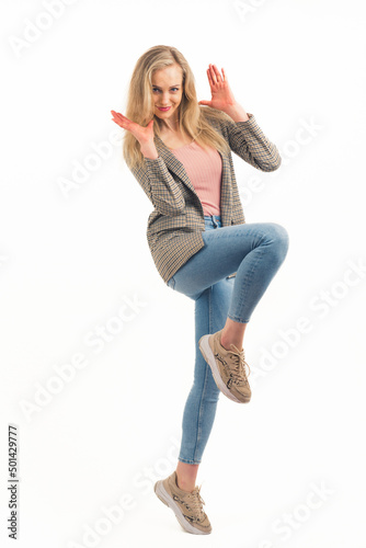 surprised beautiful European blonde girl smiling into the camera full shot studio shot white background copy space. High quality photo
