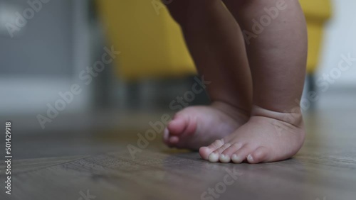 Wallpaper Mural close-up baby infant feet, little foot moving fingers toes, trying to stand for the first time. baby toddler naked legs, learning to step or walk. barefoot and bare feet little children indoors floor  Torontodigital.ca