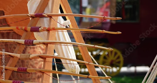 weapons bows and arrows attached to a bracket next to the tent