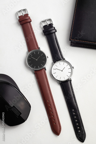 Watches with brown and black leather strap on white office desk