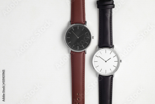 Watches with brown and black leather strap on white office desk