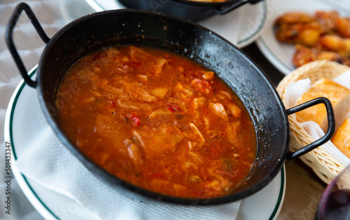 Traditional Spanish tripe dish Callos cooked with chickpea, chorizo and paprika in tomato sauce. High quality photo