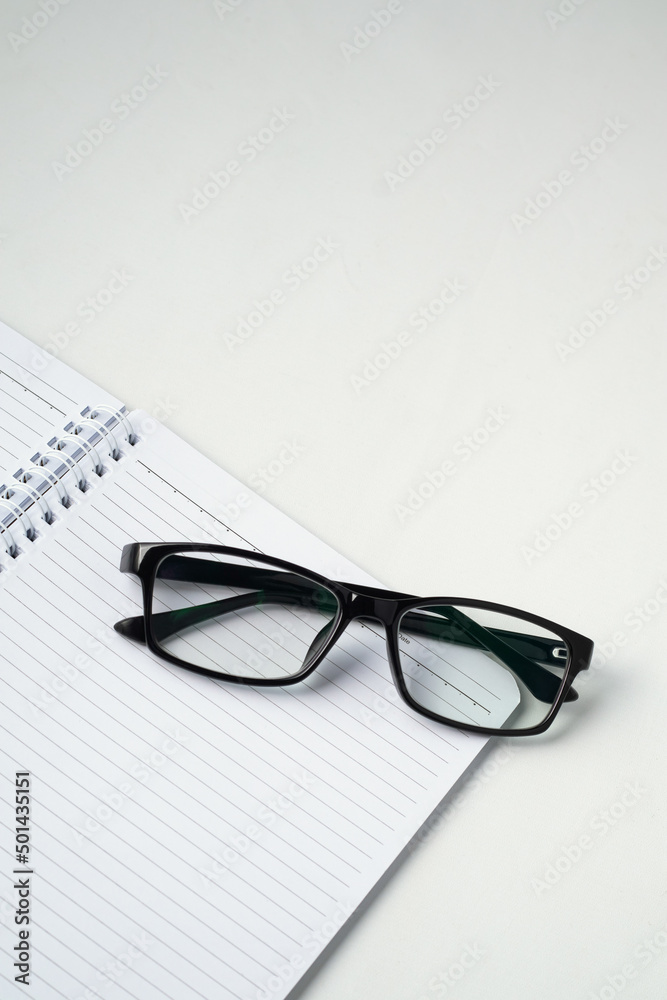 Stylish eyeglasses on white office desk. white work desk Stylish eyeglasses on white office desk. white work desk