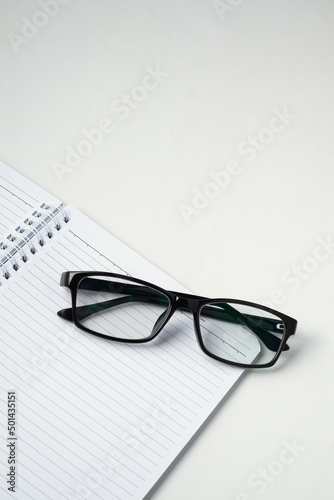 Stylish eyeglasses on white office desk. white work desk