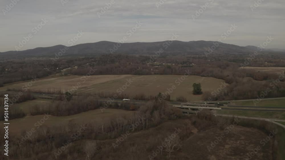 A beautiful landscape with mountains in the background of a highway with light traffic in a rural area. A beautiful landscape with mountains in the background of a highway with light traffic in a rural area.