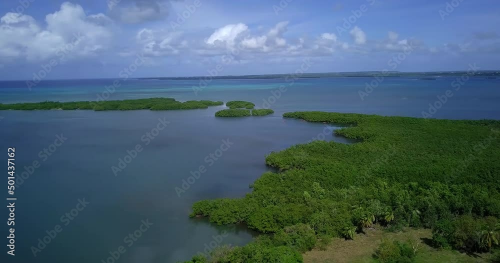 Aerial view of a green bay with people kayaking. Mangrove islands rising from the Caribbean sea. Aerial view of a green bay with people kayaking. Mangrove islands rising from the Caribbean sea.