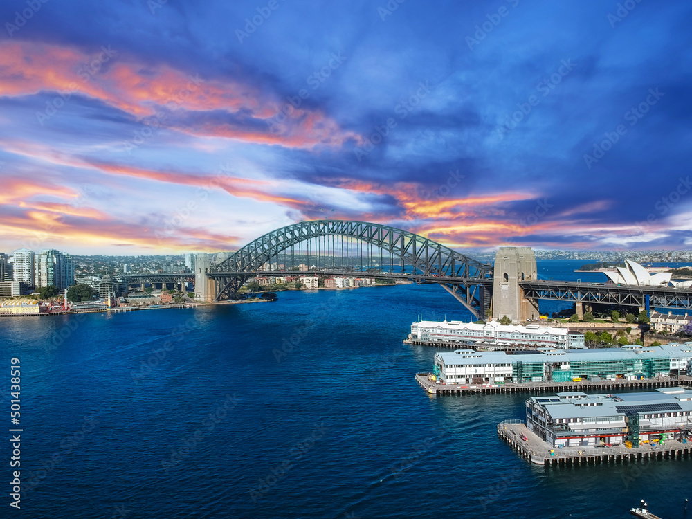 Naklejka premium Sydney Harbour Australia with nice colours in the sky. Nice blue water of the Harbour, high rise offices and residential buildings of the City in the background, NSW Australia