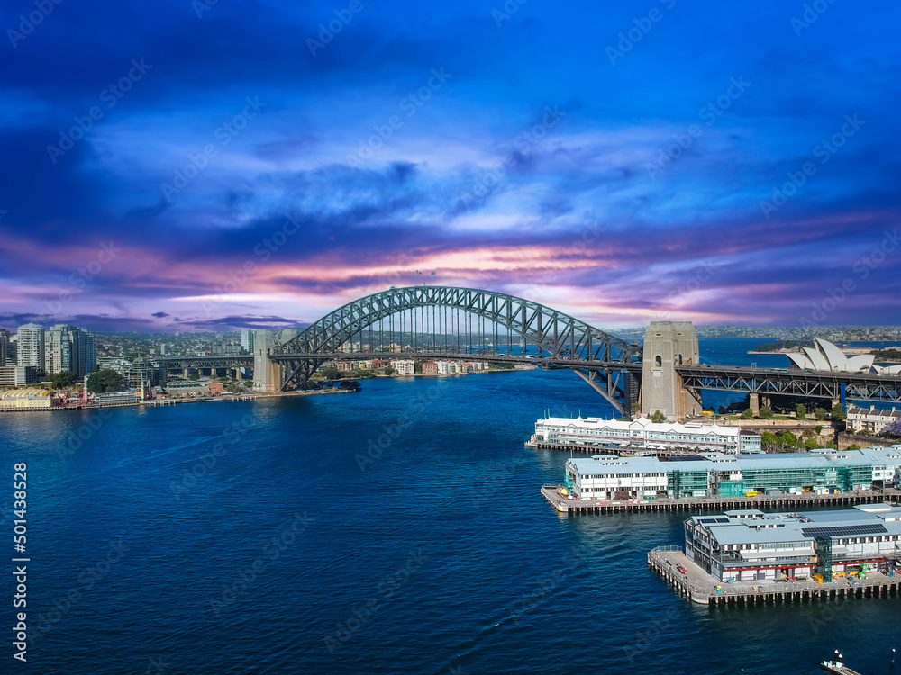 Obraz premium Sydney Harbour Australia with nice colours in the sky. Nice blue water of the Harbour, high rise offices and residential buildings of the City in the background, NSW Australia