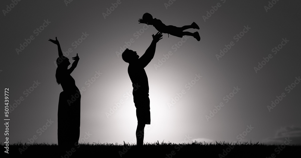 Family of three pregnant mother father and child playing at sunset Family of three pregnant mother father and child playing at sunset