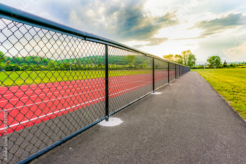 Low perspective image from outside new running track looking toward perimeter fence and horizon © Thomas