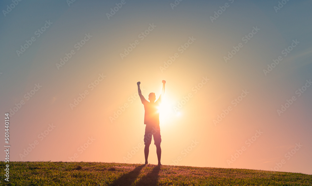 Strong fit motivated man feeling empowered and determined with fist up to the sky