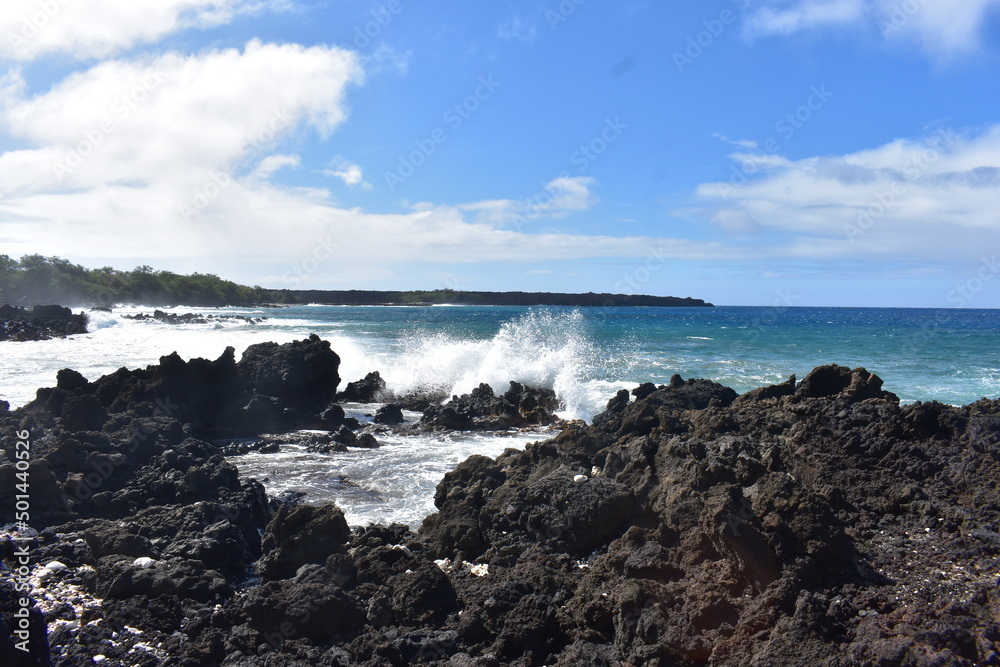 Maui Hawaii lava field with waves crashing on rocks Maui Hawaii lava field with waves crashing on rocks