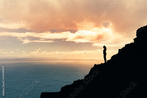 Woman standing mountain at sunrise. Travel Lifestyle emotional concept adventure summer vacations outdoor hiking mountaineering feeling at peace with nature
