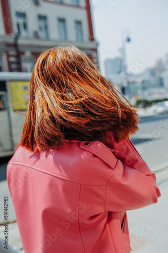 stylish image of urban fashion. bright pink leather jacket on woman without face. spring female look. cozy style clothes. selective focus