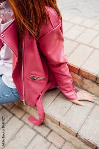 stylish image of urban fashion. bright pink leather jacket and jeans on woman without face. spring female look. cozy style clothes. selective focus