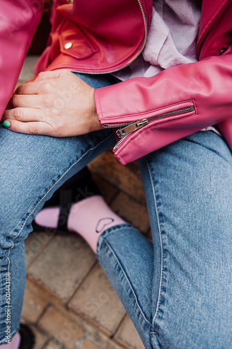 stylish image of urban fashion. bright pink leather jacket and jeans on woman without face. spring female look. cozy style clothes. selective focus