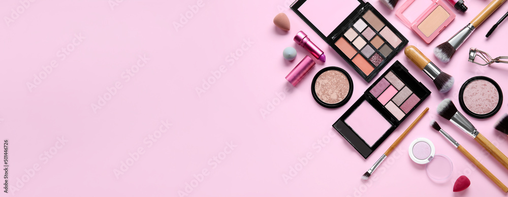 Fototapeta Makeup brushes and decorative cosmetics on pink background with space for text, top view
