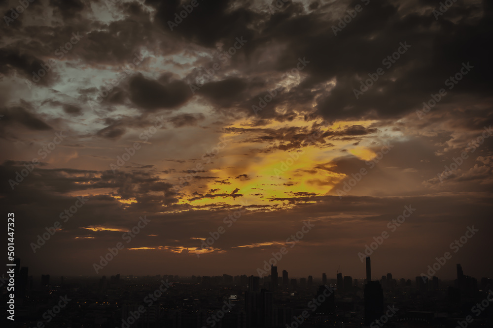 Gorgeous scenic of the sunrise or sunset with cloud on the orange sky over large metropolitan city in Bangkok. Copy space, No focus, specifically. Gorgeous scenic of the sunrise or sunset with cloud on the orange sky over large metropolitan city in Bangkok. Copy space, No focus, specifically.