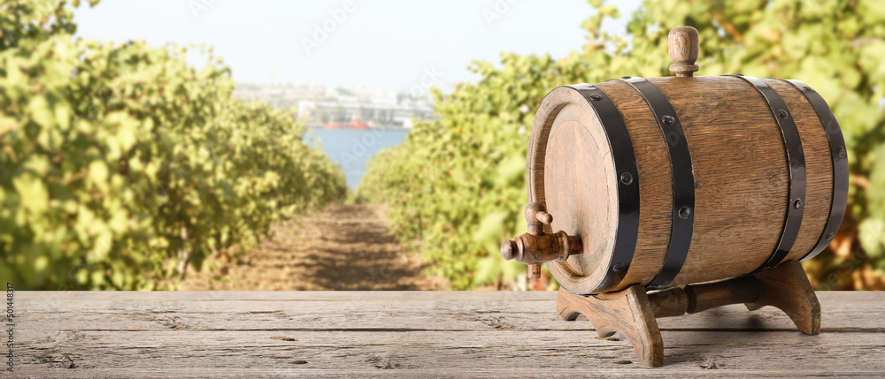 Wooden barrel of wine on table in vineyard Wooden barrel of wine on table in vineyard