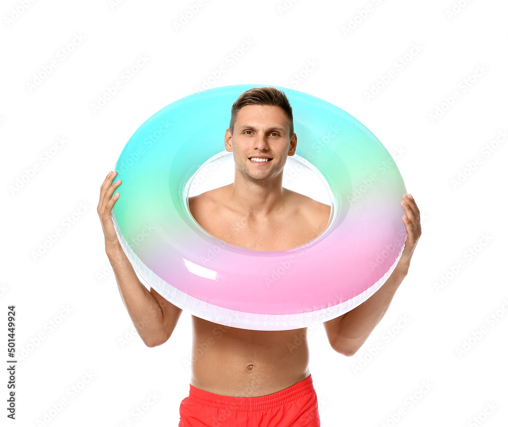Attractive young man with inflatable ring on white background