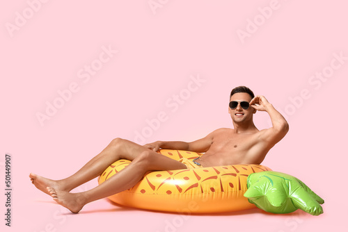 Happy young man with inflat...