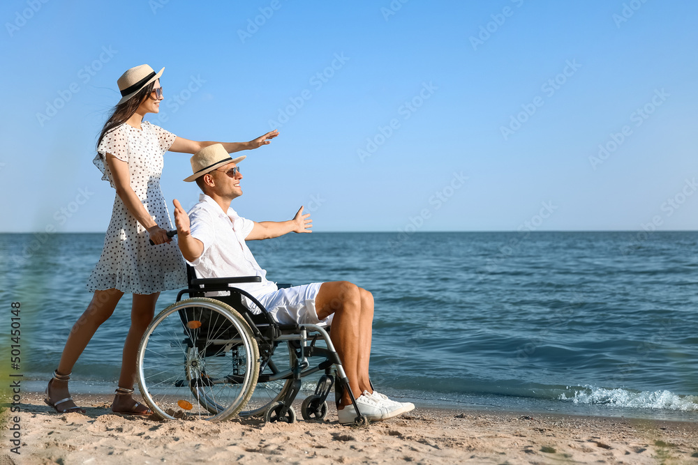 Happy man with physical disability and his girlfriend at sea resort Happy man with physical disability and his girlfriend at sea resort