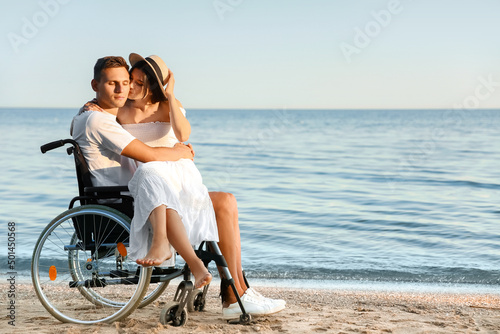 Happy man with physical disability and his girlfriend at sea resort © Pixel-Shot