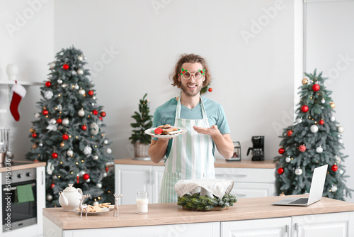 Young man holding plate wit...