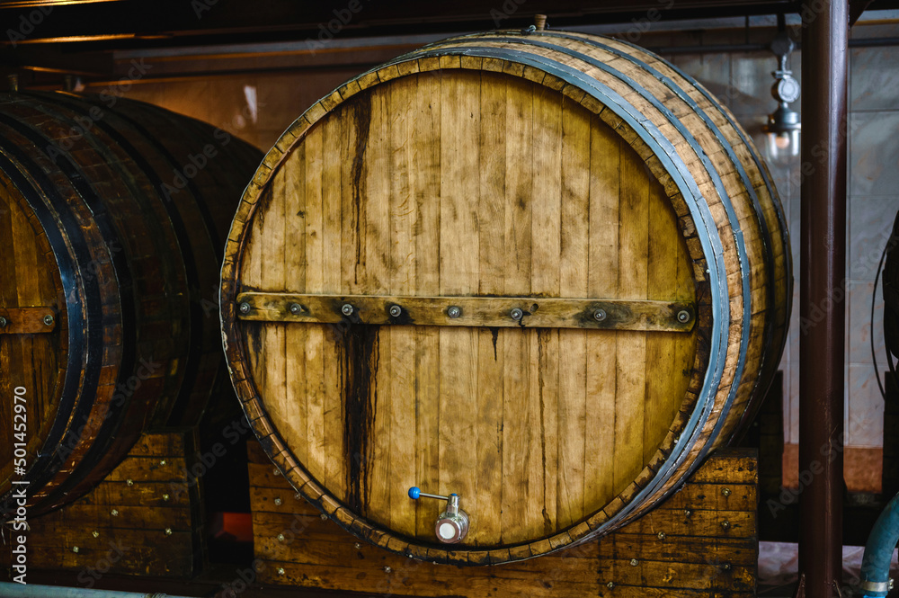 Fototapeta premium Wooden cask to make luxury alcohol drinks stand in cellar