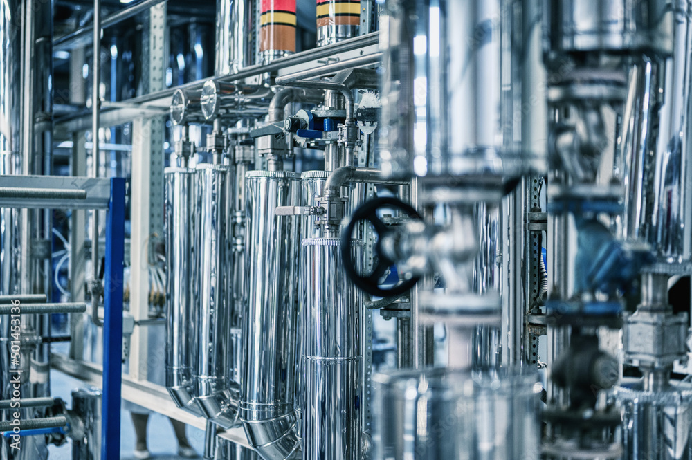 Large tube with small black valve at production plant Large tube with small black valve at production plant