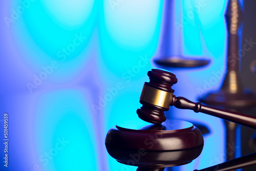 Lawyer office. Law symbols composition: judge’s gavel and scale. Blue light background.