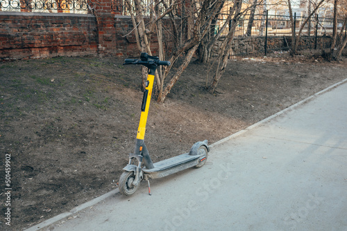 Dirty electric scooter on the street.