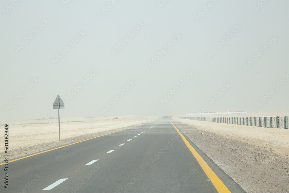 Dessert road in sandstorm hazy out of focus with grain