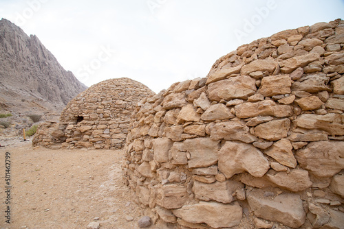 circular tombs with domes in Arabian desert build with rocks photo